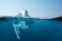 Iceberg in the ocean with a view under water. Crystal clear water. Hidden Danger And Global Warming Concept.