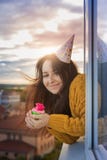 A young girl is celebrating her birthday alone