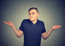 Ignorance. Man shrugging shoulders who cares so what isolated on gray background. royalty free stock photography Ignorance. Man shrugging shoulders who cares so what isolated on gray background. royalty free stock photography