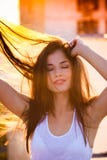 Il bello ritratto sorridente della giovane donna gode di di estate del tramonto immagine stock libera da diritti Il bello ritratto sorridente della giovane donna gode di di estate del tramonto immagine stock libera da diritti