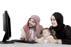 Arabian family using a computer on studio stock photography Arabian family using a computer on studio stock photography