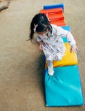 Image of happy cute little kid girl playing on colorful playground outdoor. Playful child running and jumping outside. stock images Image of happy cute little kid girl playing on colorful playground outdoor. Playful child running and jumping outside. stock images