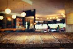 Image of wooden table in front of abstract blurred background of restaurant lights Stock Images Image of wooden table in front of abstract blurred background of restaurant lights Stock Images