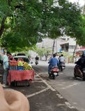 In this images the fruit sellar selling many types of fruits on the road of the corner and peoples are also in the pics royalty free stock photos In this images the fruit sellar selling many types of fruits on the road of the corner and peoples are also in the pics royalty free stock photos