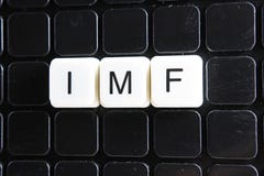 IMF title text word crossword. Alphabet letter blocks game texture background. White alphabetical letters on black royalty free stock images IMF title text word crossword. Alphabet letter blocks game texture background. White alphabetical letters on black royalty free stock images
