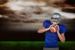 Immagine composita di distogliere lo sguardo bianco della palla della tenuta del giocatore di football americano immagine stock libera da diritti Immagine composita di distogliere lo sguardo bianco della palla della tenuta del giocatore di football americano immagine stock libera da diritti