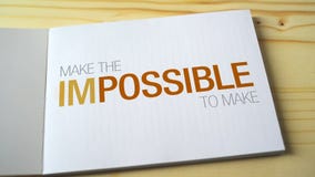 Impossible becomes possible by fading letters printed on the notebook page.