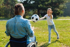 Incapacitated young man catching ball thrown by daughter royalty free stock images Incapacitated young man catching ball thrown by daughter royalty free stock images