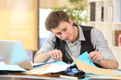 Incompetent messy businessman with disorganized desk stock photo Incompetent messy businessman with disorganized desk stock photo