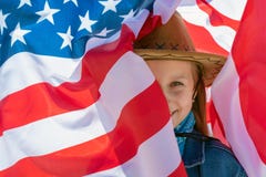 Independence Day. Beautiful happy girl with green eyes on the background of the American flag on a bright sunny day royalty free stock photo Independence Day. Beautiful happy girl with green eyes on the background of the American flag on a bright sunny day royalty free stock photo