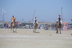 Indian men play camel polo at Desert Festival in Jaisalmer, Rajasthan, India