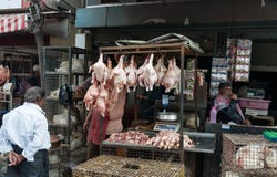 Indian men sell chicken on Russell Market in Bangalore Royalty Free 