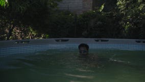 Indischer Kerl in schwimmenden Hemden tragen Taucherbrille und Schwimmen im Pool der Kinder stock video footage Indischer Kerl in schwimmenden Hemden tragen Taucherbrille und Schwimmen im Pool der Kinder stock video footage