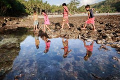 Group of poor poverty children play on the beach stock photo Group of poor poverty children play on the beach stock photo