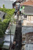 Indonesian Muslim woman wearing the veil walks down a back alley in Jakarta, Indonesia stock image Indonesian Muslim woman wearing the veil walks down a back alley in Jakarta, Indonesia stock image