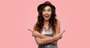 Indoor shot of attractive girl crosses arms over chest, hesitates between two items in shop royalty free stock images Indoor shot of attractive girl crosses arms over chest, hesitates between two items in shop royalty free stock images