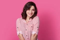 Indoor shot of pleasant looking fashionable woman with stylish haircut, makeup, smiles gently, looks with happiness at camera, royalty free stock images Indoor shot of pleasant looking fashionable woman with stylish haircut, makeup, smiles gently, looks with happiness at camera, royalty free stock images