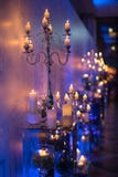 Indoors wedding decoration in the evening with candles and fir b