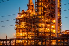 Industrial oil petrochemical refinery factory or plant with pipes and petroleum towers with night illumination stock photo Industrial oil petrochemical refinery factory or plant with pipes and petroleum towers with night illumination stock photo