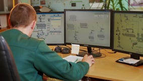Industrial worker in control room production plant