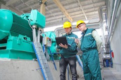 Industrial Workers With Notebook Stock Photo Industrial Workers With Notebook Stock Photo