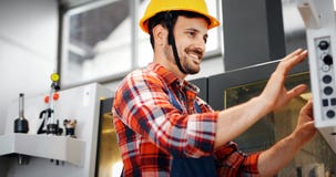 Industry Worker entering data in CNC machine at factory royalty free stock photo Industry Worker entering data in CNC machine at factory royalty free stock photo