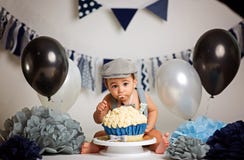 Infant boy`s first birthday cake smash Adorable baby smashing cake royalty free stock images Infant boy`s first birthday cake smash Adorable baby smashing cake royalty free stock images