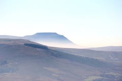 Ingleborough rising above mist in North Yorkshire