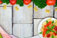 Ingredients for cooking Italian pasta - farfalle, tomatoes, peppers and basil on old wooden background. Top view with space for te royalty free stock images Ingredients for cooking Italian pasta - farfalle, tomatoes, peppers and basil on old wooden background. Top view with space for te royalty free stock images