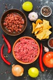 Ingredients for cooking Mexican chili con carne dishes on a black concrete background, top view. royalty free stock photography Ingredients for cooking Mexican chili con carne dishes on a black concrete background, top view. royalty free stock photography