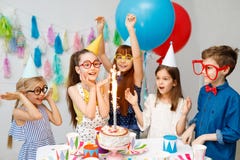 Innenschuß von glücklichen frohen Kindern betrachten großen Schein auf Kuchen, feiern Geburtstag, ungeschickte große Schauspiele lizenzfreie stockfotos Innenschuß von glücklichen frohen Kindern betrachten großen Schein auf Kuchen, feiern Geburtstag, ungeschickte große Schauspiele lizenzfreie stockfotos