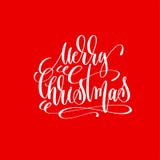 Inscripción de las letras de la mano de la Feliz Navidad en fondo rojo Imagen de archivo libre de regalías Inscripción de las letras de la mano de la Feliz Navidad en fondo rojo Imagen de archivo libre de regalías