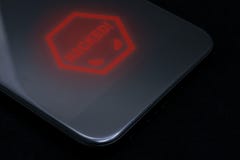 The inscription hacked on a shiny black smartphone. Hacking a smartphone. Information security. Hacking a phone or tablet royalty free stock photography The inscription hacked on a shiny black smartphone. Hacking a smartphone. Information security. Hacking a phone or tablet royalty free stock photography