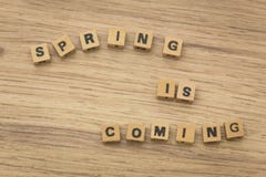 Inscription / Spring is coming / arranged from blocks strung on a string Stock Photography Inscription / Spring is coming / arranged from blocks strung on a string Stock Photography