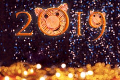 Inscrição 2019 com as caras dos porcos, o símbolo de 2019 no horóscopo chinês contra o bokeh bonito das luzes foto de stock Inscrição 2019 com as caras dos porcos, o símbolo de 2019 no horóscopo chinês contra o bokeh bonito das luzes foto de stock