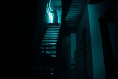 Inside Of Old Creepy Abandoned Mansion. Silhouette Of Horror Ghost Standing On Castle Stairs To The Basement. Spooky Dungeon Stone Stock Photos Inside Of Old Creepy Abandoned Mansion. Silhouette Of Horror Ghost Standing On Castle Stairs To The Basement. Spooky Dungeon Stone Stock Photos