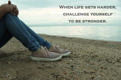 Inspirational Quote-When life gets harder, challenge yourself to be stronger. With a thoughtful young woman sitting in the beach