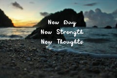 Inspirational quote - New Day. New Strength. New Thoughts. On Blurry background of morning light over the beach at sunrise.