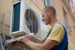 Installer sets a new air conditioner Stock Photography Installer sets a new air conditioner Stock Photography