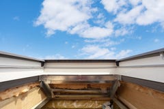 Installing Skylight roof window in New Modern Passive Wooden House against blue sky. stock images Installing Skylight roof window in New Modern Passive Wooden House against blue sky. stock images