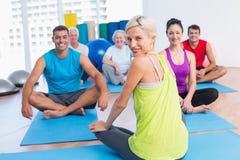 Instructor with class practicing yoga in fitness studio royalty free stock photo Instructor with class practicing yoga in fitness studio royalty free stock photo