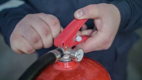 Instructor teaches the use of a fire extinguisher, close up royalty free stock images Instructor teaches the use of a fire extinguisher, close up royalty free stock images