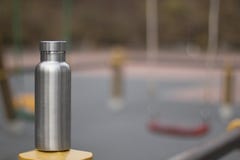 Insulated Stainless Bottle with a children´s playground in winter background stock photo Insulated Stainless Bottle with a children´s playground in winter background stock photo