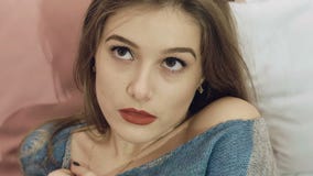 Intelligentes Mädchen, das auf dem Bett stillsteht, liegt und aufwirft langsam stock footage Intelligentes Mädchen, das auf dem Bett stillsteht, liegt und aufwirft langsam stock footage