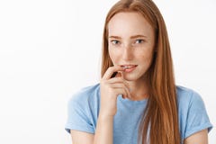 Interesting let me think about it. Intrigued flirty and feminine charming redhead female with cute freckles holding stock photo Interesting let me think about it. Intrigued flirty and feminine charming redhead female with cute freckles holding stock photo