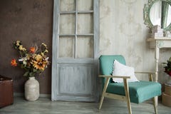 Interior retro room with an armchair, flowers, door and mirror Royalty Free Stock Photography Interior retro room with an armchair, flowers, door and mirror Royalty Free Stock Photography