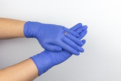 Interlocked hands of woman with protective gloves and a ring on the finger