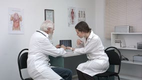 Intern showing doctor the x-ray on the screen of the tablet. stock video Intern showing doctor the x-ray on the screen of the tablet. stock video