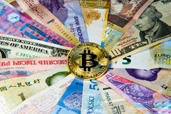 International currency bitcoin Conceptual image of bitcoin internationalism. Physical coin bitcoin on the banknotes of royalty free stock photo International currency bitcoin Conceptual image of bitcoin internationalism. Physical coin bitcoin on the banknotes of royalty free stock photo