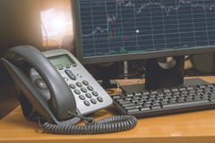 IP telephone with computer keyboard and monitor display financial chart on screen Stock Image IP telephone with computer keyboard and monitor display financial chart on screen Stock Image